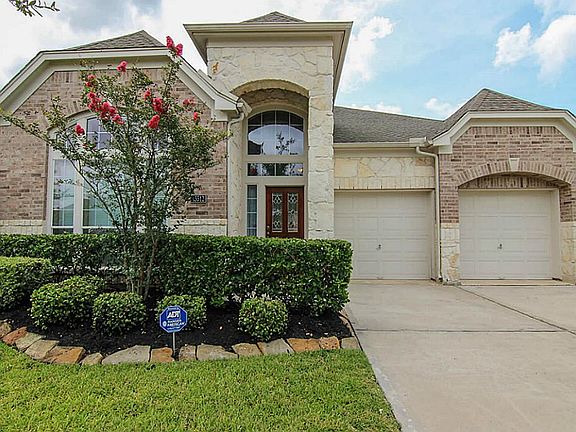 Beautiful landscaping and a stone and brick elevation.