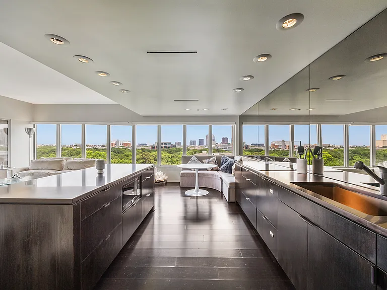 Sleek kitchen with a built-in refrigerator and extensive cabinetry.