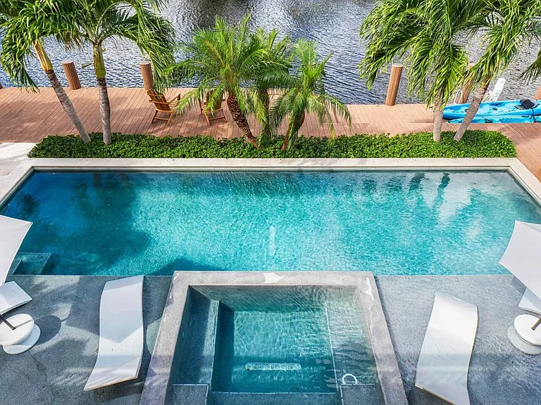 Resort-style pool with Baja deck and lounge chairs, perfect for soaking up the sun and enjoying the Florida warmth.