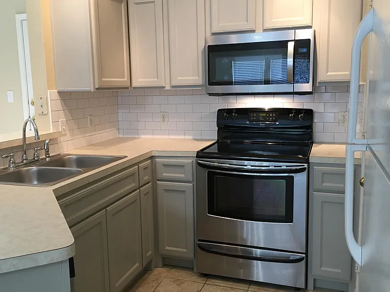 New/upgraded kitchen appliances and sink. Newly installed/painted custom-built lower cabinets. New subway tile backsplash.