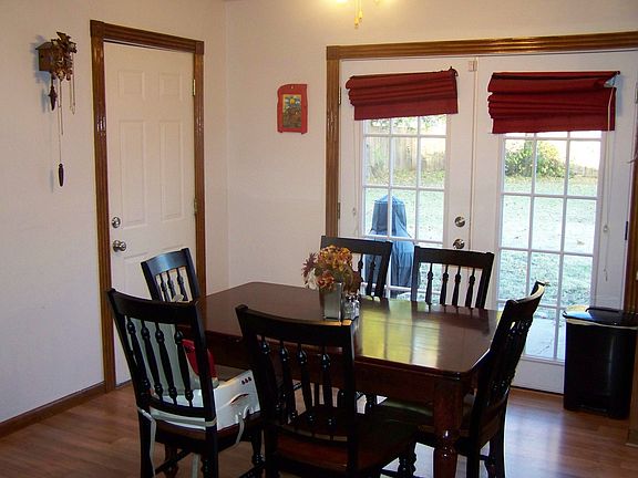 New laminate flooring in dining room and kitchen. New french doors too!