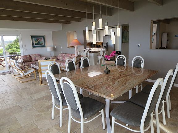 Dining room and sitting area looking towards kitchen. Dining room table is granite.