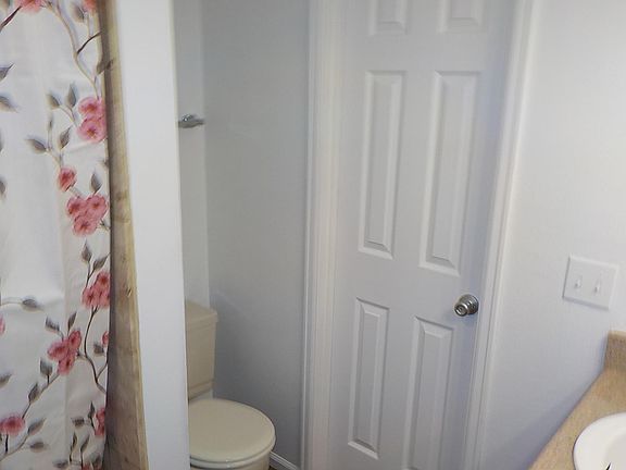 Bathroom with tub and one sink for the front bedroom.