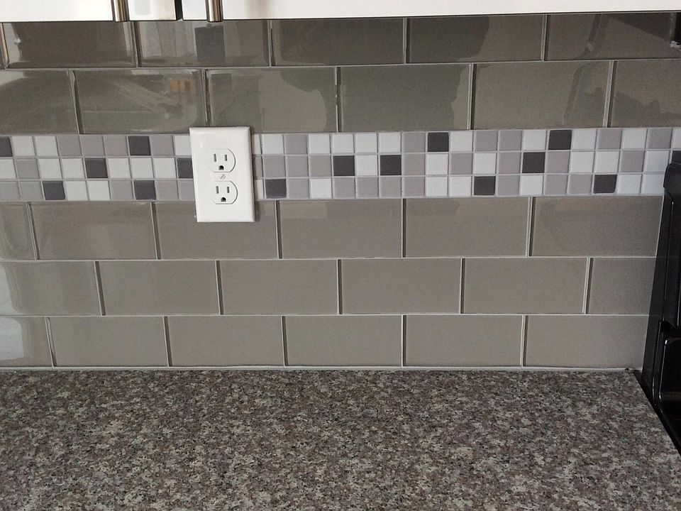 Kitchen countertops and glass backsplash with mosiac trim
