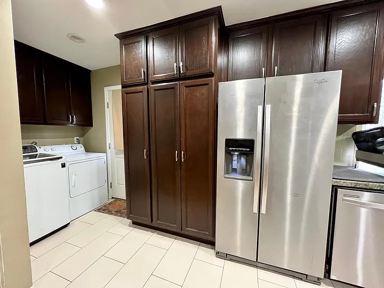 Washer / Dryer, pantry and backdoor that leads to the back yard.