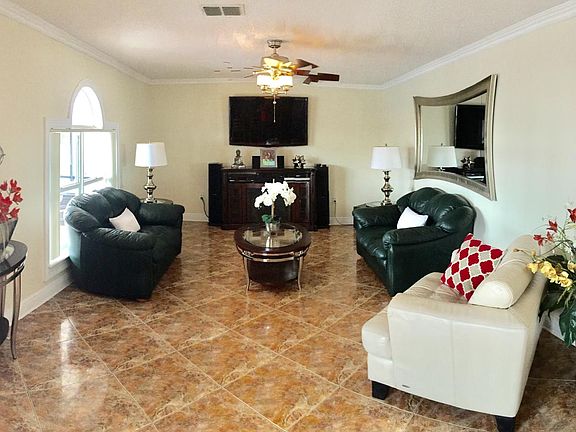 SPACIOUS OPEN LIVING ROOM WITH 52" TV, FIRE PLACE AND SURROU