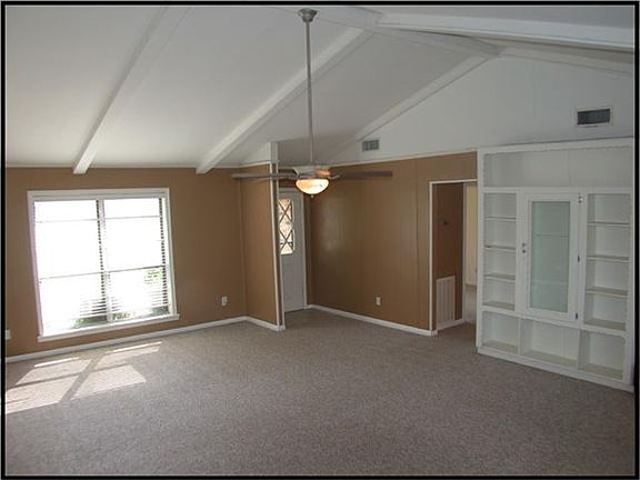 LOOKING FROM BREAKFAST ROOM BACK TOWARDS THE FRONT DOOR OF THE FAMILY ROOM.