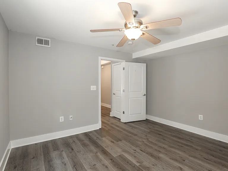 Bright Bedroom with Contemporary Flooring and Neutral Paint