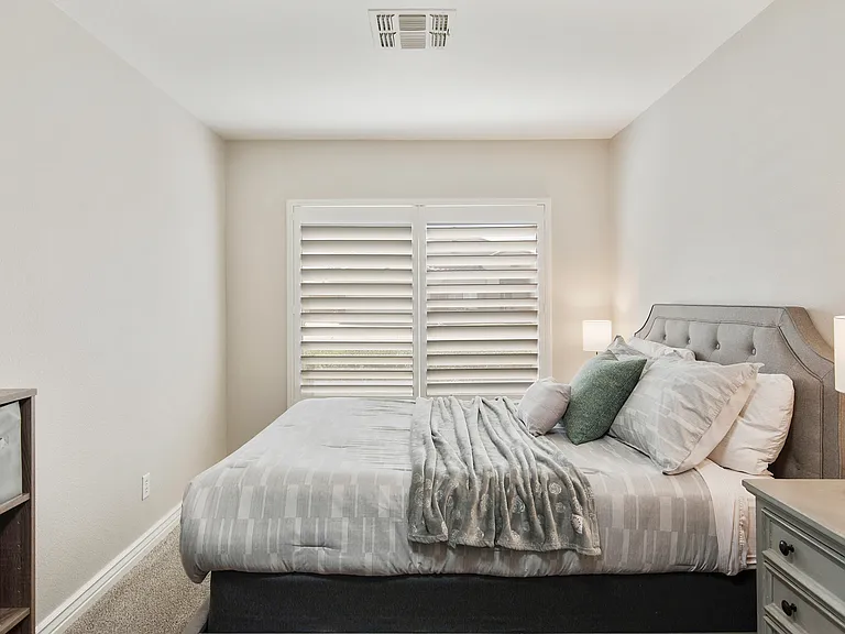 Bedroom 3 features a queen size bed, a fan, 2 nightstands, tv and 2 lounge chairs