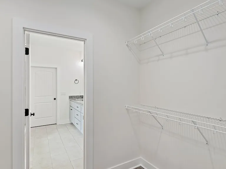 Walk-in closet leading into master bathroom