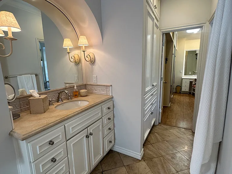 Primary bathroom en suite includes two separate vanities, separate water closet, tons of storage