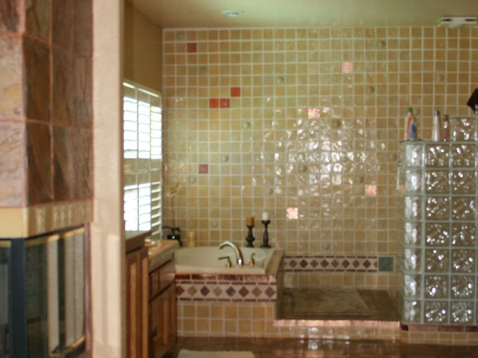 You will love this master bath with slate flooring, a walk in glass block show