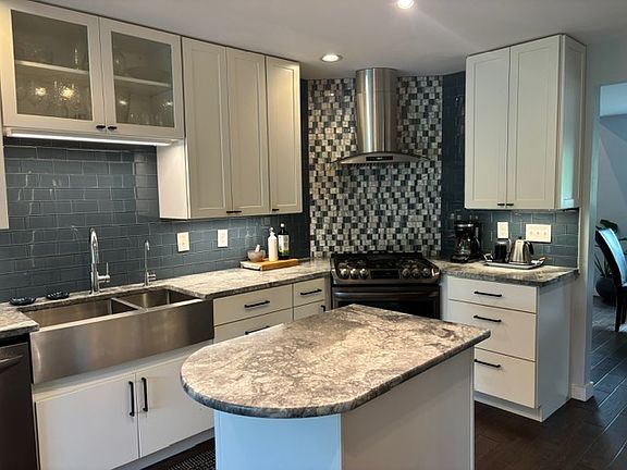 Kitchen with a center island, gas stove with griddle.