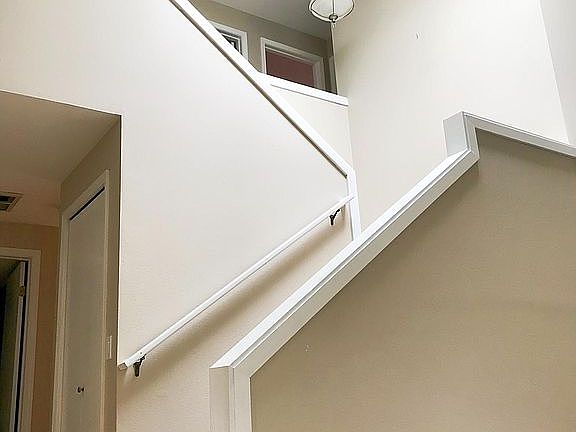Stairs to 2nd floor with natural skylight. 