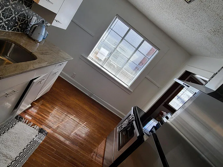 Kitchen with new Granite Countertops with Original Metal Cabinets, Stainless Steel Appliances, and Custom Tile Backsplash