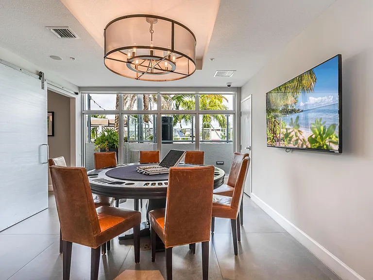 Private Event Room Featuring Leather Chairs, Wall-Mounted TV, and Outdoor Views