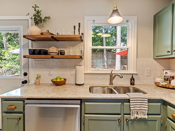 View of the kitchen from the breakfast nook. Open shelves keep things easy to reach and in view, while all the other items you''ll need during your stay are stored in the cabinets.