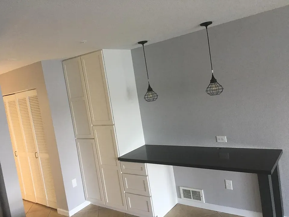 Pantry and work desk with custom desk drawers.