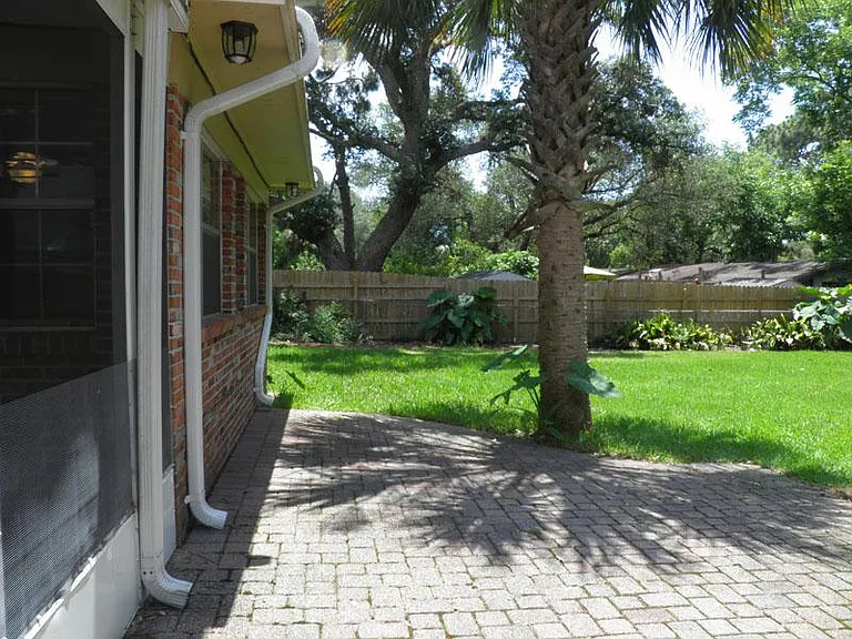 Outdoor patio behind screened in porch