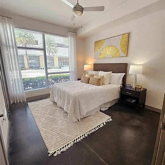 Wake up to natural light streaming in through a large window, making your bedroom feel fresh and airy.