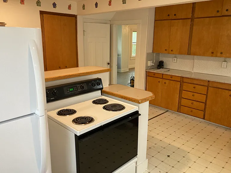 Another shot of kitchen showing door to basement and doorway to office