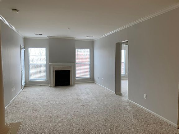Living Room with fireplace and glass door to balcony