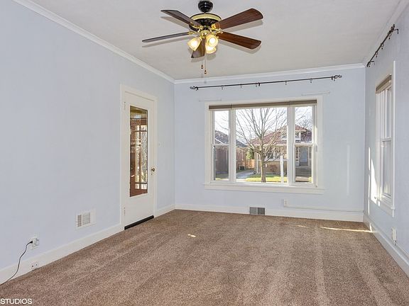 Living Room with newer carpet, windows and hardwood floors under the carpet!