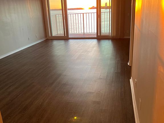 Spectacular sunset view as you and your guests enter living room / balcony area. (The white dot on floor is a lens reflection.)