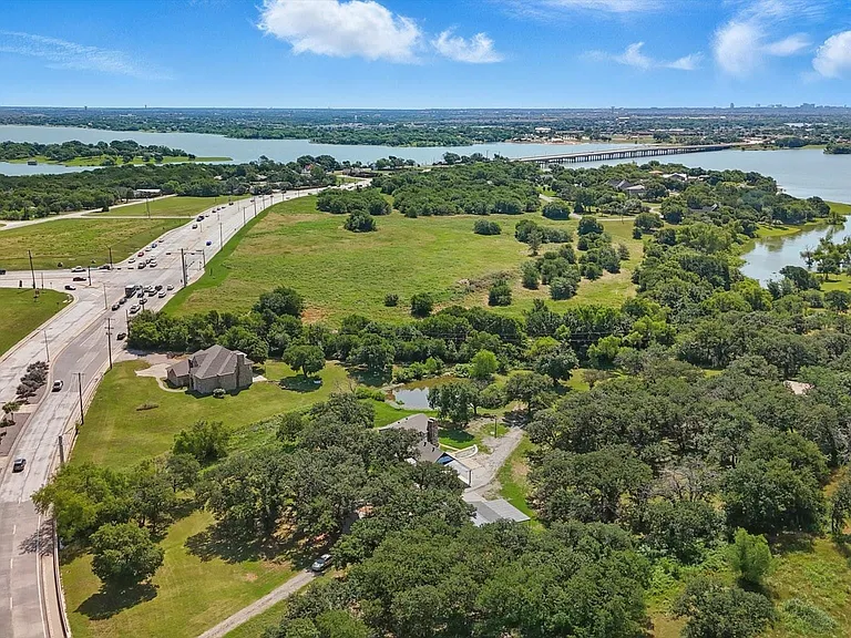Aerial view of a nearby body of water and a major roadway