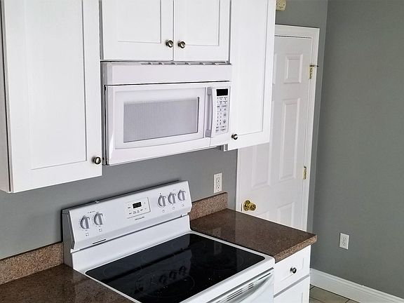 Eat-in Kitchen - sunny with lots of windows and light, solid wood white cabinets, granite countertops, ceramic tiled floor, all appliances