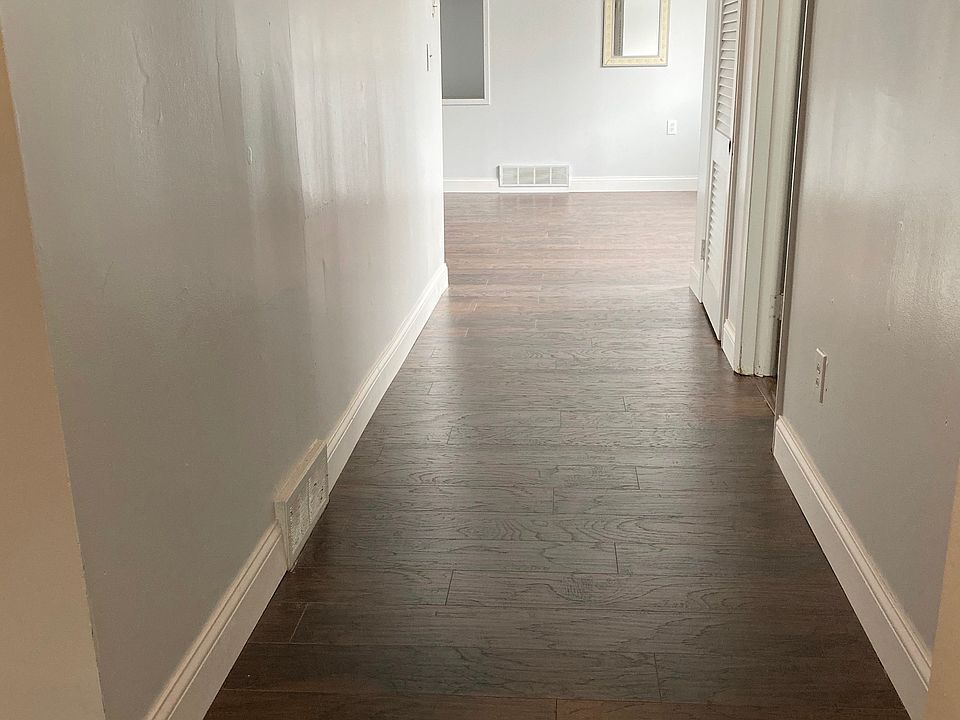 Hallway leading into living room with all new flooring