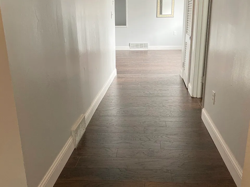 Hallway leading into living room with all new flooring