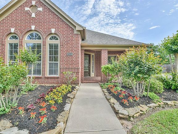 Walking up to the front of this home, you will be greeted by Colorful Foliage.