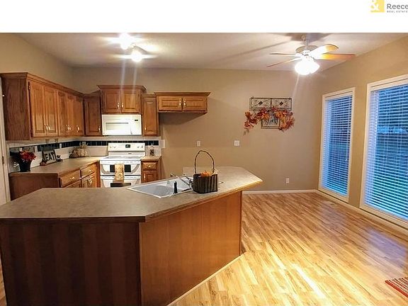 Large eatin kitchen with lots of windows, beautiful laminate floors, breakfast bar and large pantry.