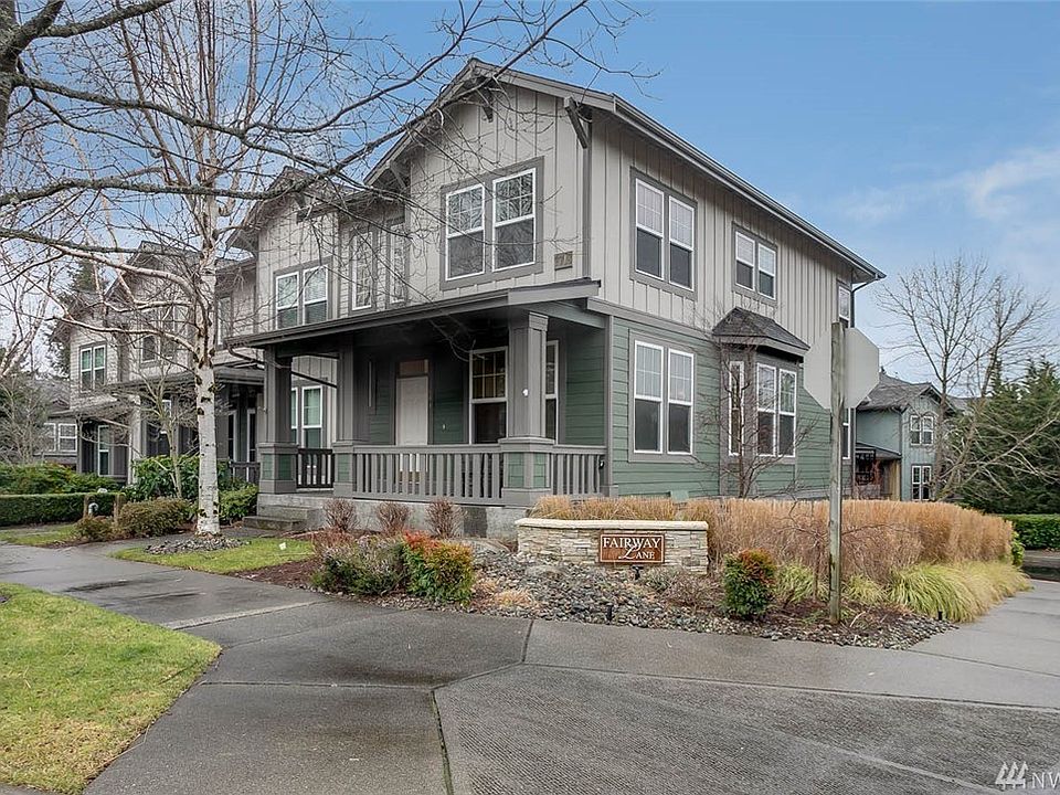Welcome home to Fairway Lane and this spacious 3 bedroom, 3 bath multi-level townhome with abundant curb appeal and covered front porch. Perfect for gatherings, the formal living and dining rooms flow easily to the family room, spacious kitchen & informal dining area. Relax and unwind outside on the expansive deck overlooking the community greenspace. Delight in stunning mountain and sunrise views!  High ceilings and countless windows add to the light and bright feel. This sought-after floorplan boasts 3 bedrooms upstairs and a large bonus room downstairs. The welcoming master features two walls of windows, a walk-in closet and ensuite bathroom with double sinks & soaking tub. 