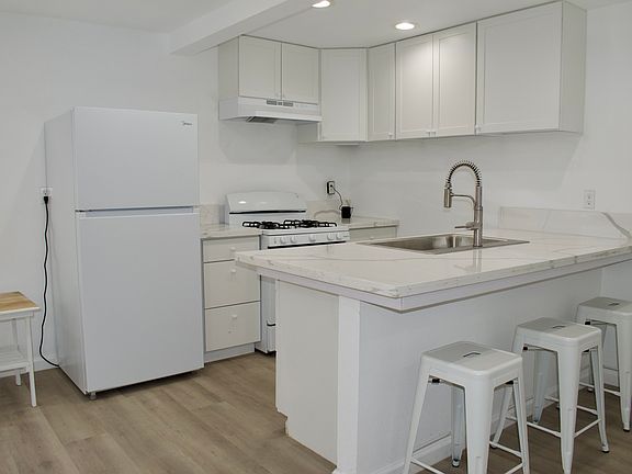 Kitchen with eating area, frig,, stove.