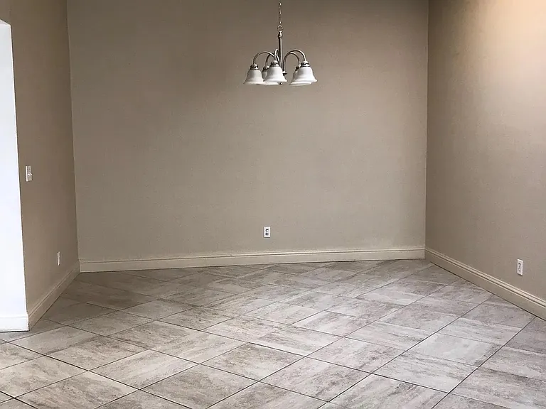 Dining room off of the kitchen, easily can accommodate a full size dining set .