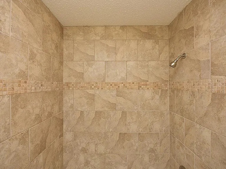 Experience luxury with this elegantly tiled shower, designed for both style and function.