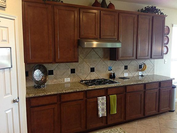 Across from Stairs to your Left is the Beautiful Gourmet Kitchen with Abundant Cabinets and Optional Granite Counter
