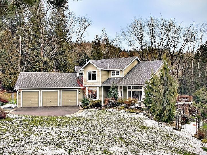 Home is set back with large lawn in front.