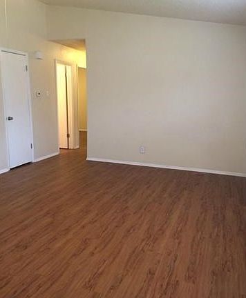 Second view of living room looking into hallway and coat/storage