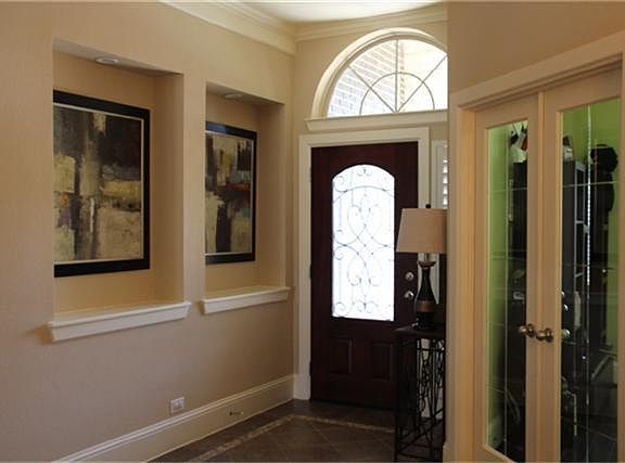 Beautiful entry with art niches, and French doors leading you to the study.