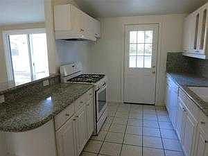 Spacious Kitchen with door leading to large backya