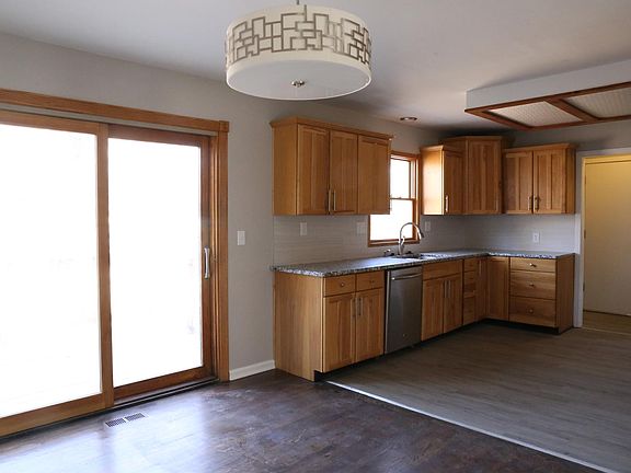 Dining room with double doors that lead to the wooden deck outside.