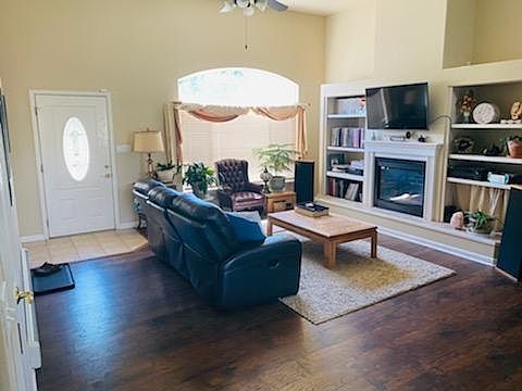 Living room with vaulted ceilings, gas fireplace and wood floors.