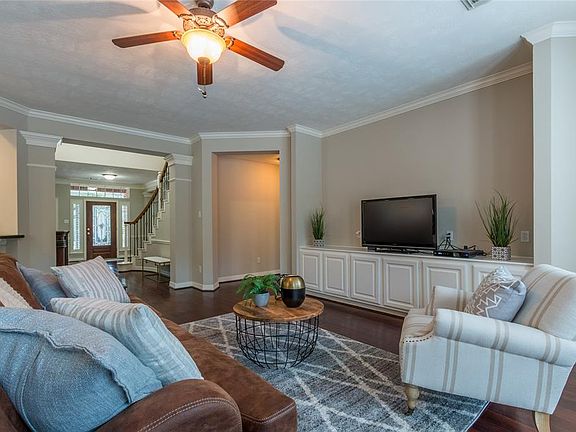 The foyer opens to the large living area with built-in shelving and room for the LARGEST OF TELEVISIONS!
