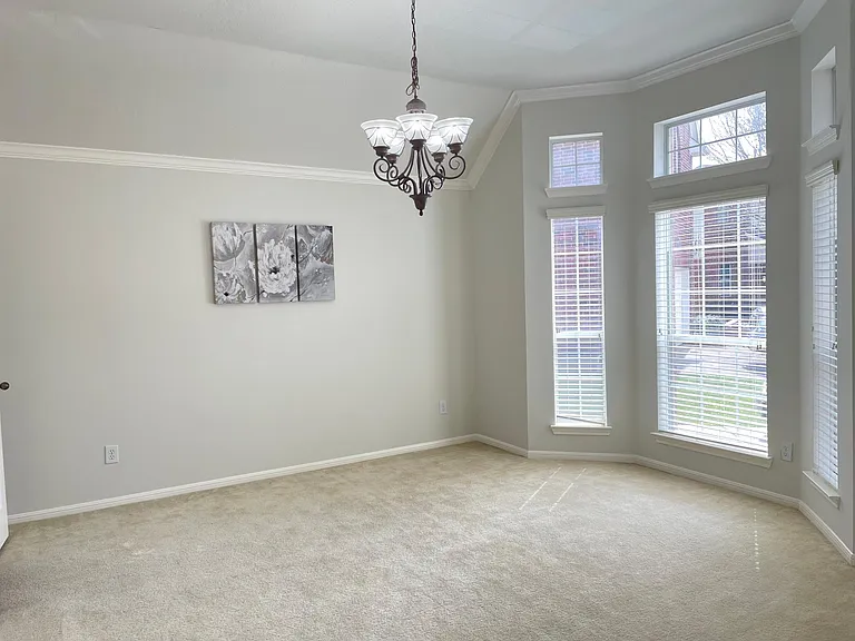 Formal dining room featuring elegant bay windows and abundant natural light.