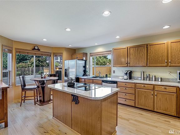 Chef's kitchen with quality Stainless Steel Appliances, an eating nook and ample counters, cabinets and pantry. Rich maple hardwood floors on entire main floor.