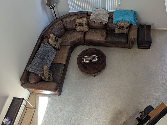 Looking down from loft to living room with fireplace
