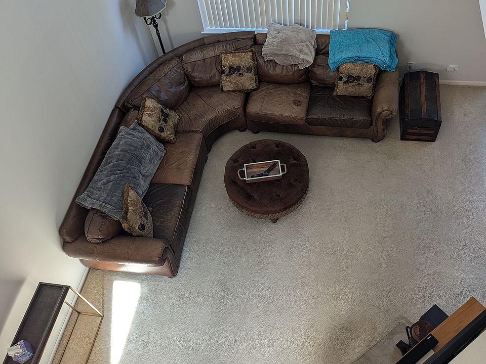 Looking down from loft to living room with fireplace